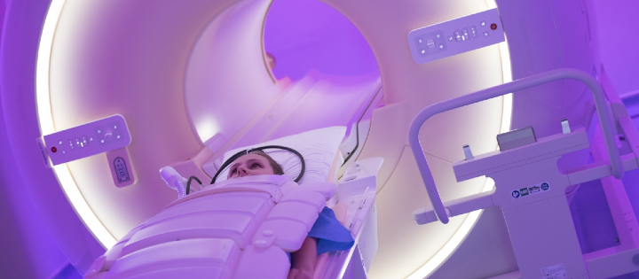 a woman entering an MRI machine