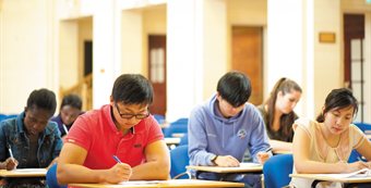 Students taking a test - full