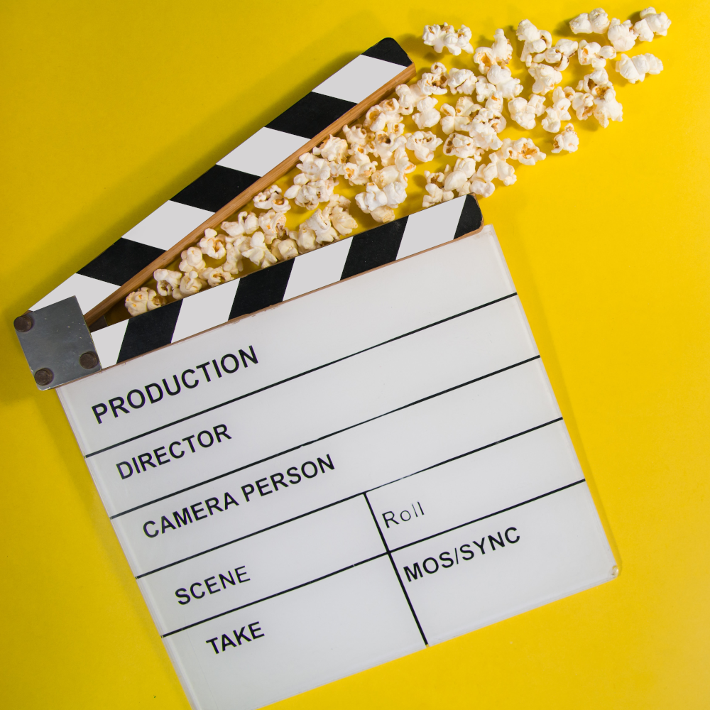 Blank film clapperboard with popcorn flying from it
