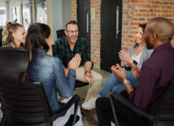 A diverse group of business people sitting chatting in a circle