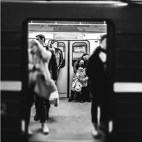 An atmospheric black and white picture of an underground train shortly before the doors shut