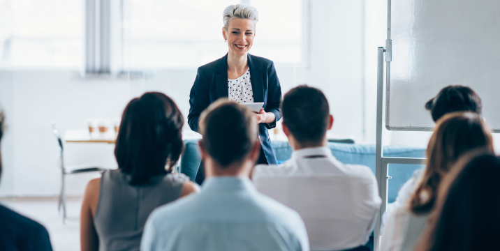 Woman presenting to a professional audience