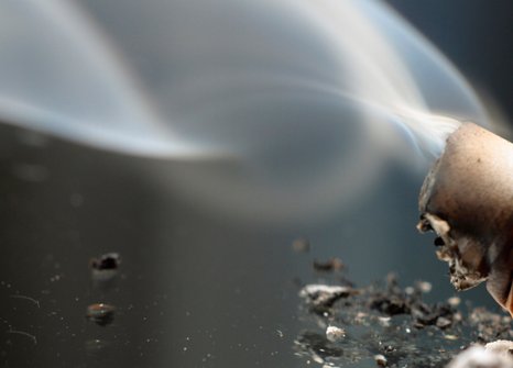 Cigarette butt with smoke
