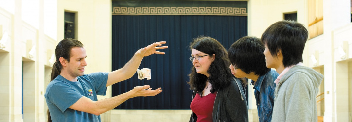 Postgraduate student performing magic in The Great Hall, University Park 714x249