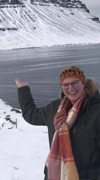 Cassidy Croci in Iceland, smiling in front of a frozen mountain