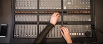 hands-working-on-recording-studio