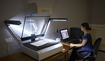 Manuscripts and Special Collections staff member using the flatbed scanner