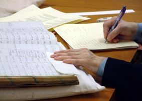 Photograph showing a reader using archival material