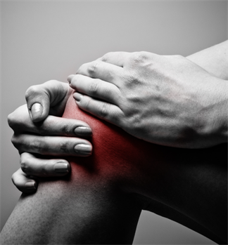 Black and white photo of a person clutching their knee which is glowing red with pain