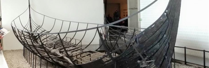 Photograph of a partially reconstructed ancient ship in a museum display