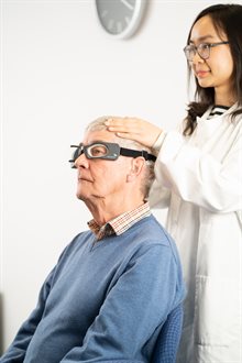 A researcher with a participant wearing tracking glasses