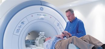 Dr Brett Haywood assisting a patient in a GE 1.5 Tesla MRI machine - Medical School, QMC
