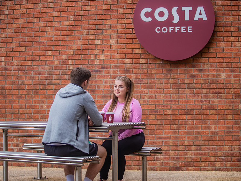 Two students outside Costa Coffee, adjacent from Jubilee Sports Centre, located on Jubilee Campus