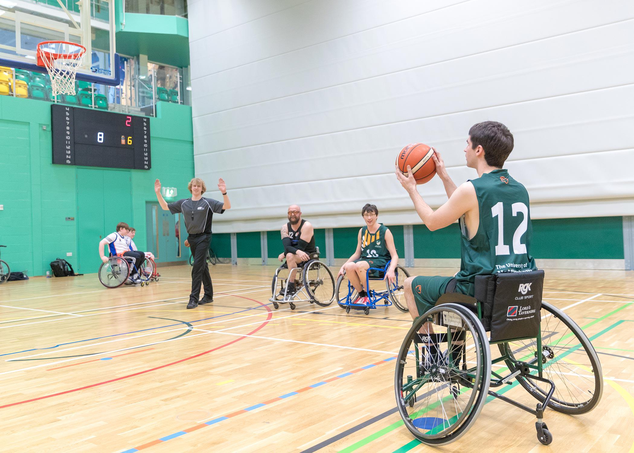 A wheelchair basketball player about to take a shot at the University of Nottingham