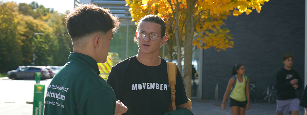 Movember student ambassadors chat outside David Ross Sports Village