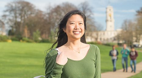 Female undergraduate student with Trent Building in the background