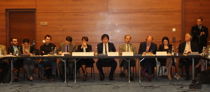 Delegates sat across a panel