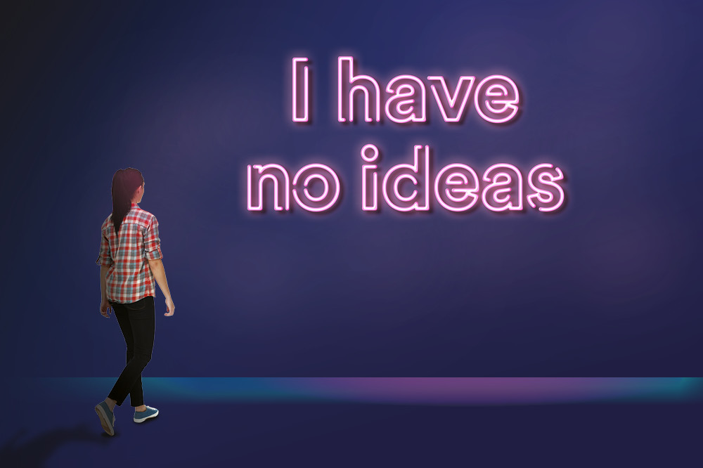 Student looking towards a sign saying 'No Ideas'