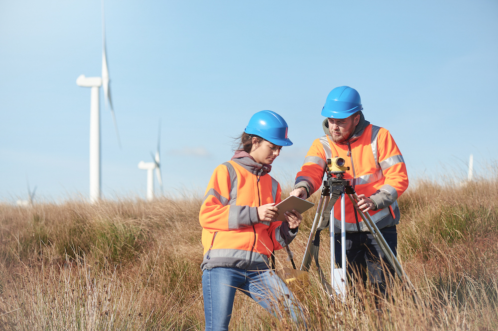 Employees in the field working on a wind farm