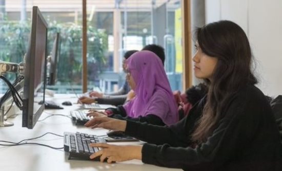 Students code in a computer science seminar