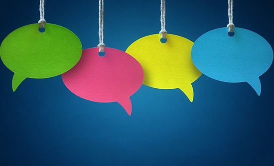Four speech bubbles hanging over a blue background