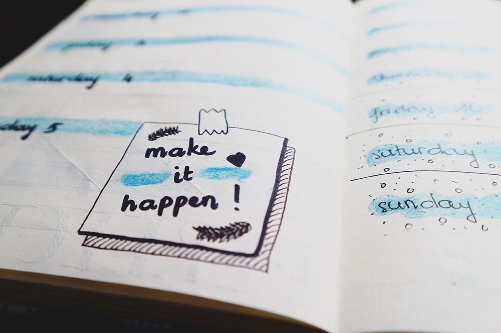 Note saying 'Make it happen' with a diary