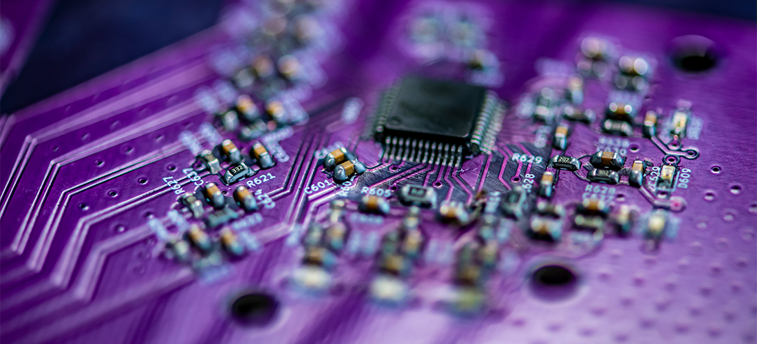 Close-up of a purple circuit board with electronics