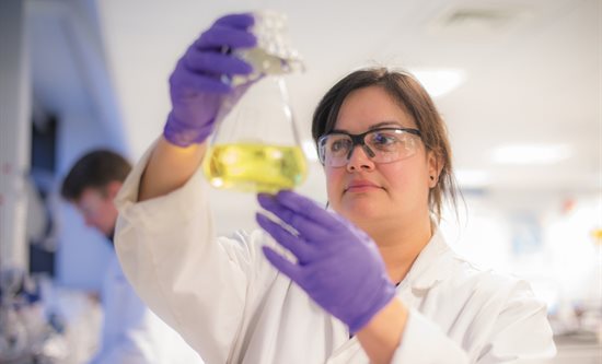 Professor Rachel Gomes looking at chemicals in a laboratory
