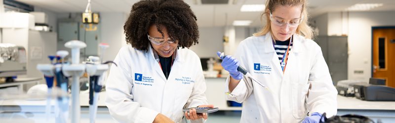 Two female PhD students working in a chemical engineering laboratory