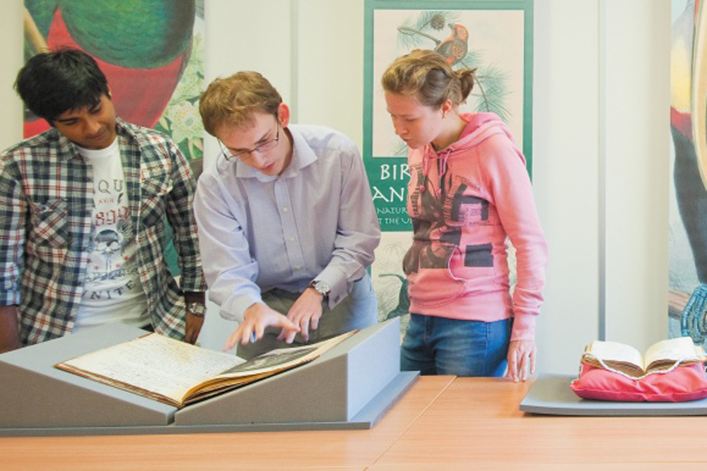 Three students at Manuscripts and Special Collections