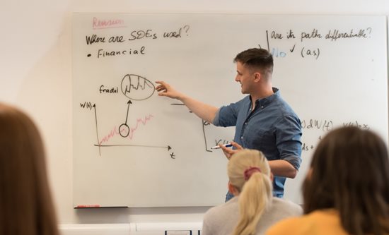 A student delivers a talk in a maths seminar