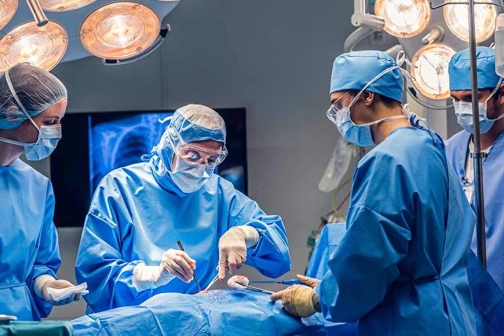 A team of surgeons in an operating theatre operating on a patient