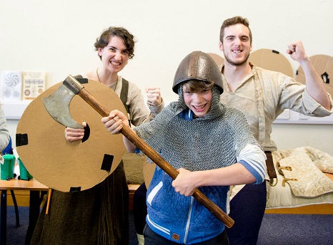 Two students with a child dressed as a Viking
