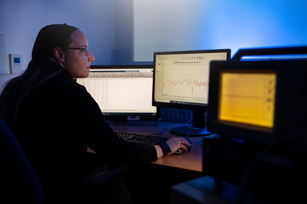 A researcher looking at multiple computer screens