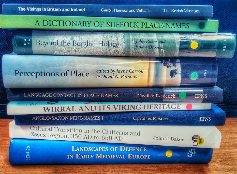 Photograph of a stack of books about place-names, their spines facing the camera