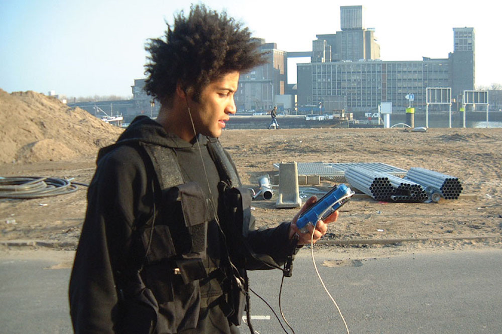 A player holding their handheld device in Can You See Me Now?
