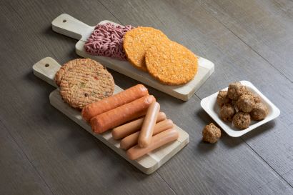 Plant based sausages burger mince on a wooden board