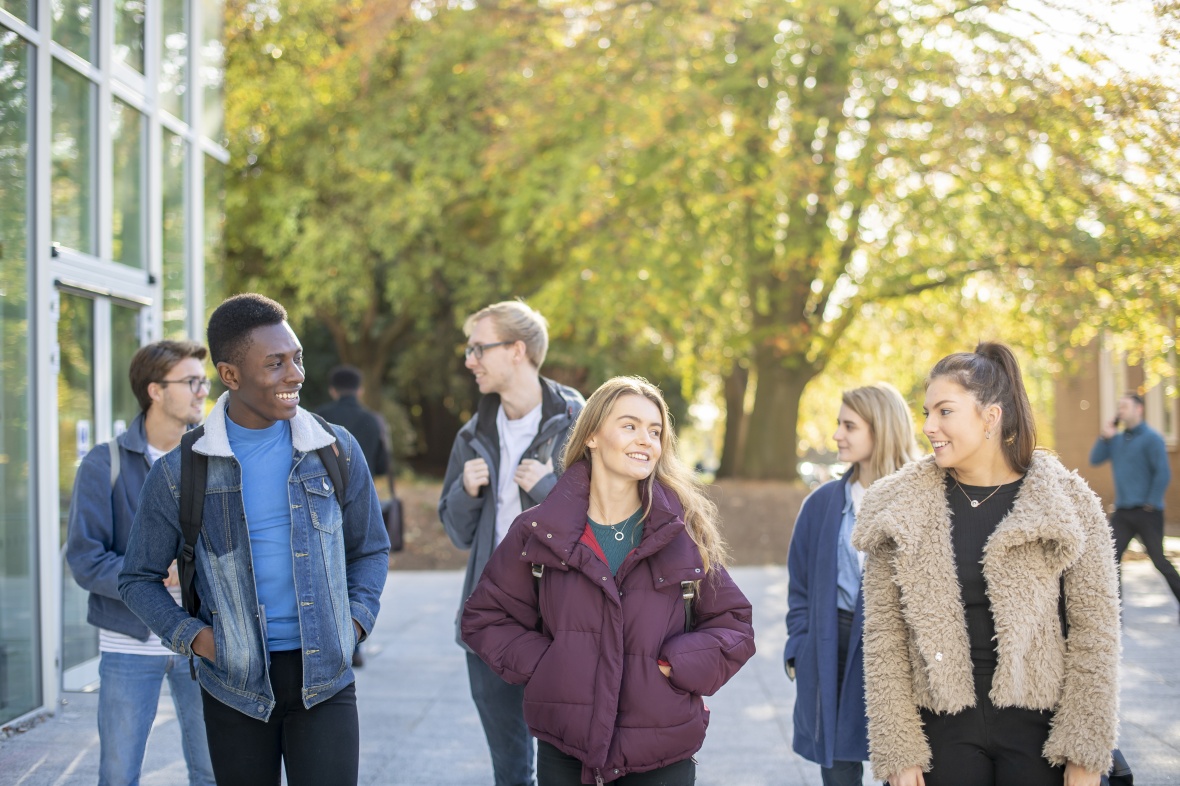 Undergraduate students walking past the Monica Partridge Building, University Park