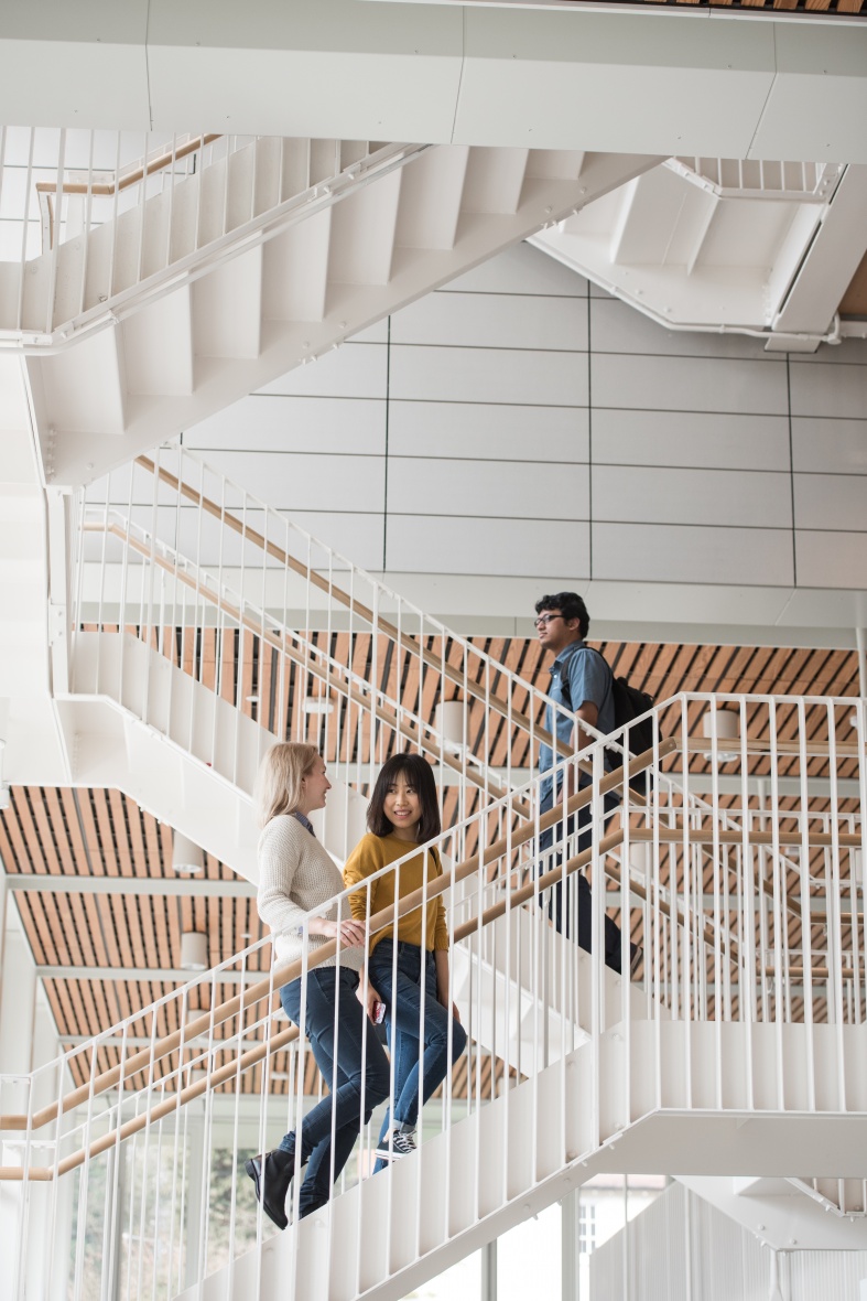 Students walking up the staircase at the Monica Partirdge building