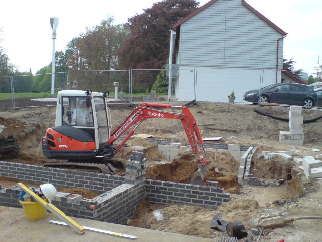 Foundations laid, below-ground walls rising.