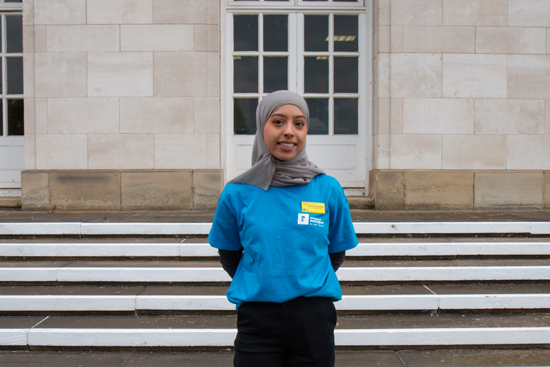 Shaha standing in front of some steps.