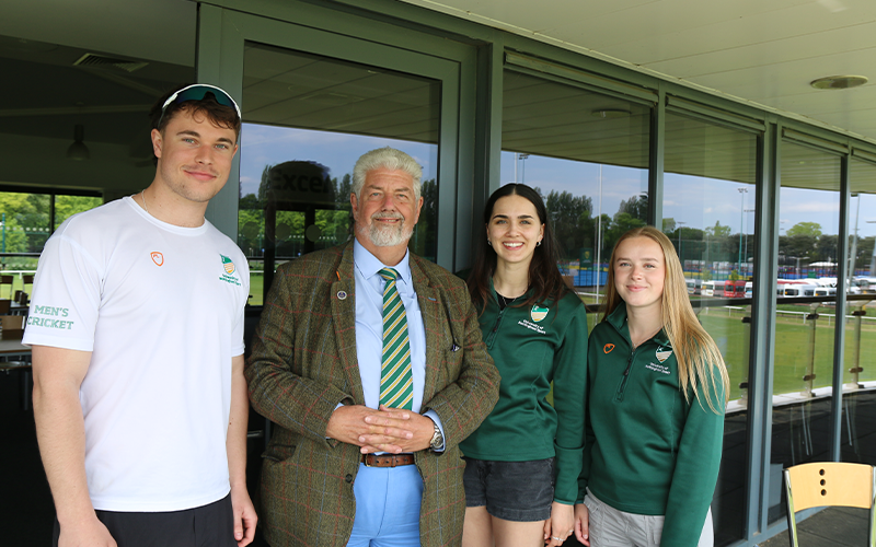 Alumni and cricket donor Alan Budge with student cricketers Max, Cassie and Georgia