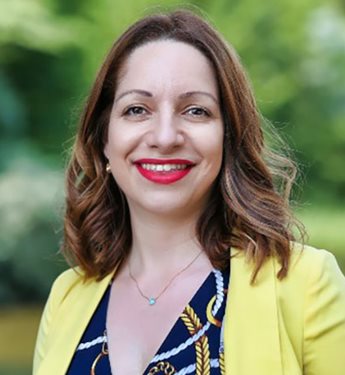 Head and shoulders photo of  Dr Andri Georgiadou. Trees are visible in the background.