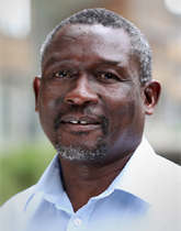 Head and shoulders photo of Professor Musa Mangena. Musa is wearing a white shirt.