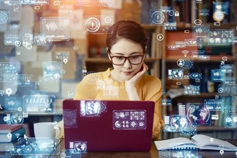 Female student using a laptop surrounded by digital technology icons