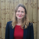 Head and shoulders photo of Liz Walkley. Liz has blonde hair and is wearing a red shirt with a blue jacket.