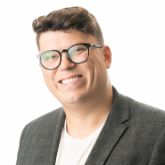 Head and shoulders photo of Mike Reid. Mike has brown hair and is wearing a grey jacket.