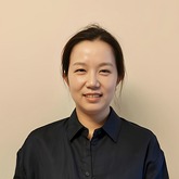 Head and shoulders photo of Ziyi Wei. Ziyi has dark hair and is wearing a dark shirt.