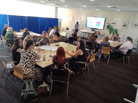 Small-group discussion in progress amongst staff teams