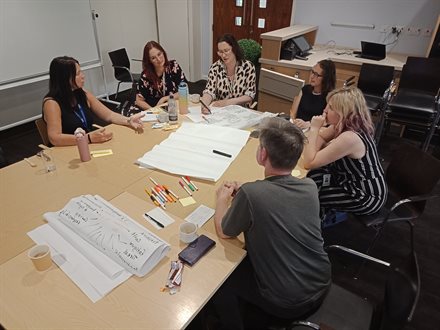 Second shot of small-group discussion in progress amongst the Cultural Participation Staff Team